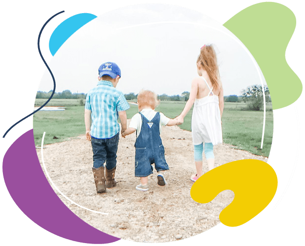 Three young kids walking on a path