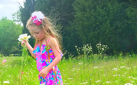 Dr Curtis' daughter playing in flowers